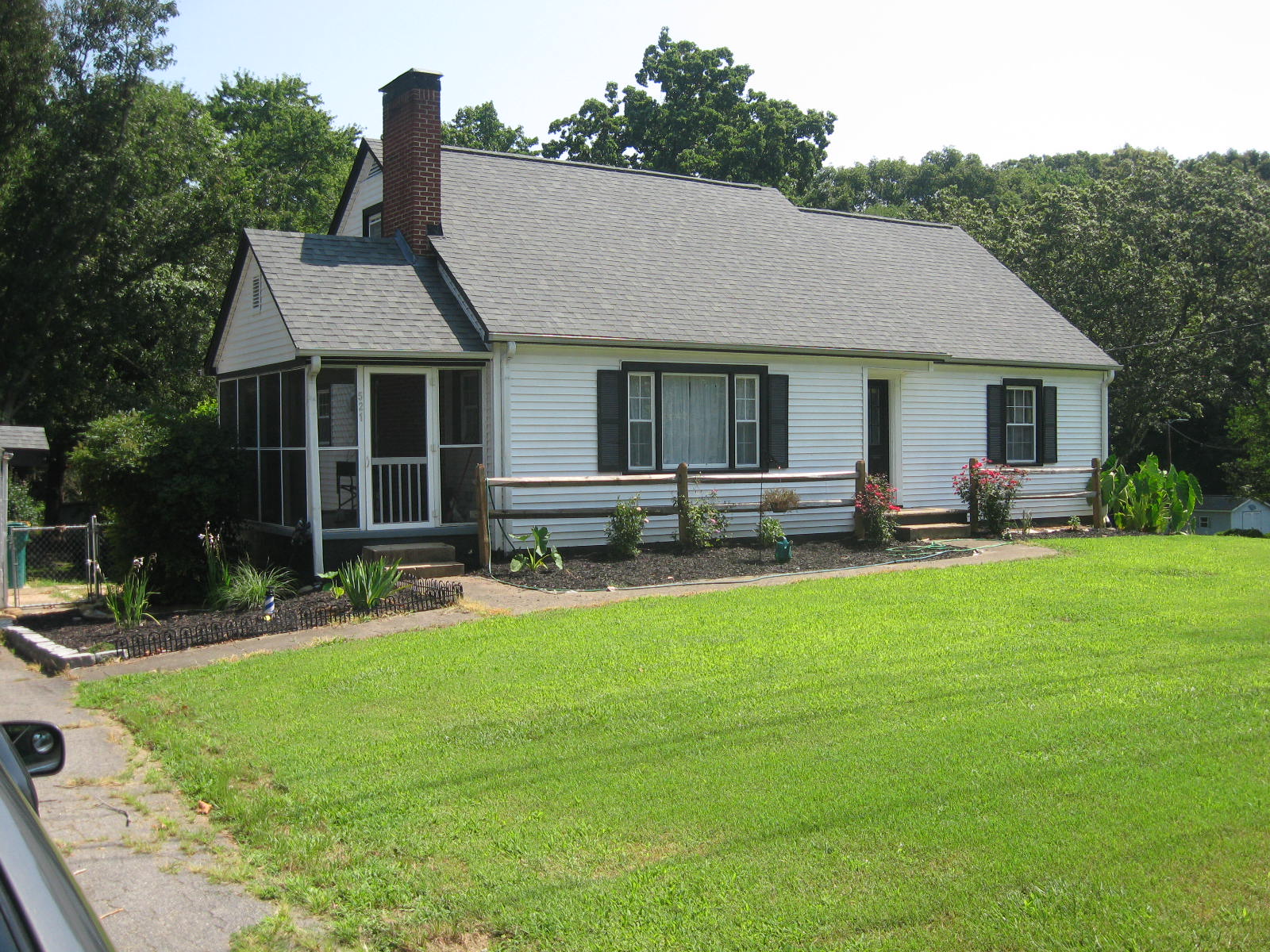 White home with green lush lawn