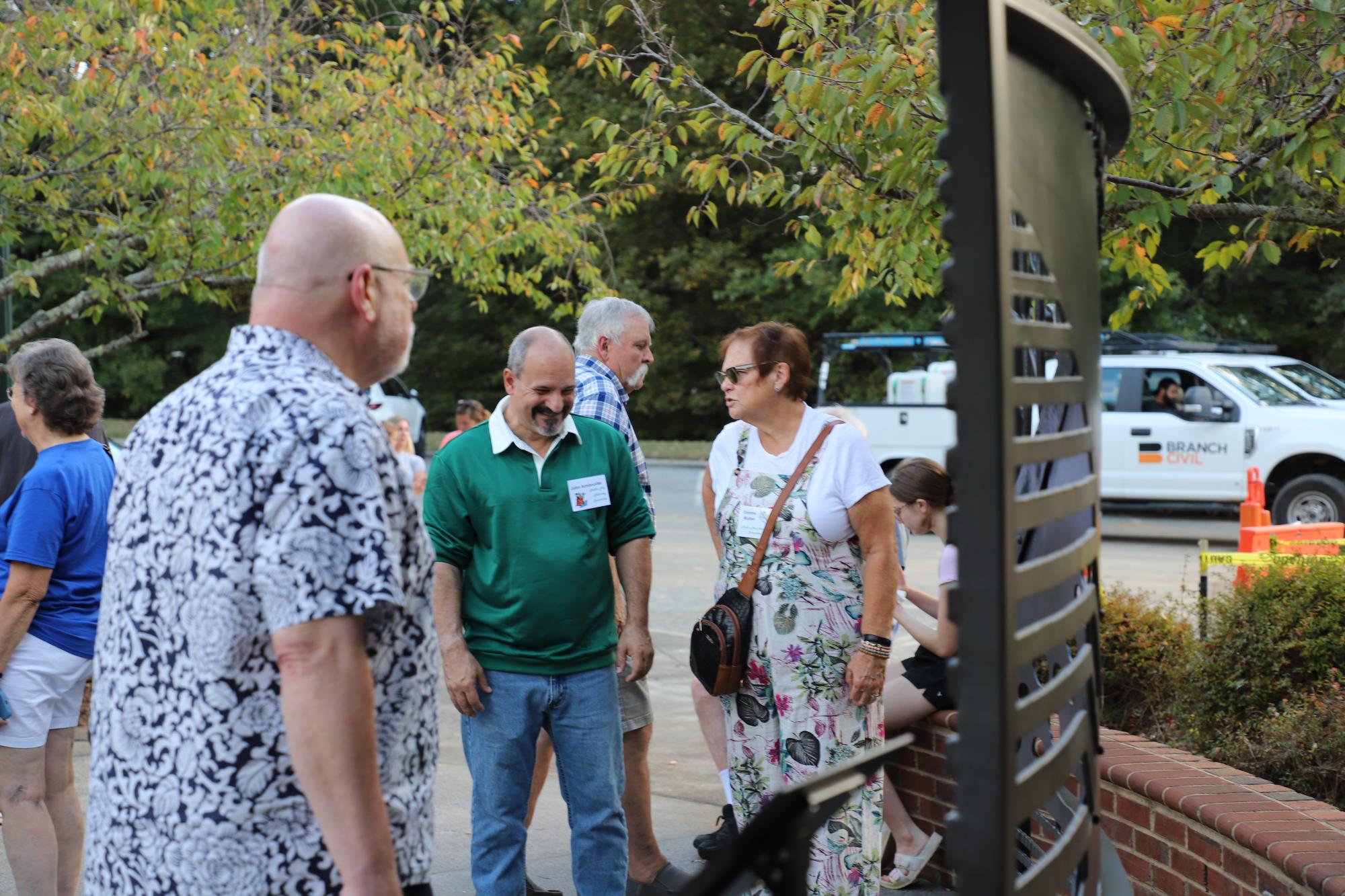 Attendees admire the newly installed art sculpture at Shallowford Square.