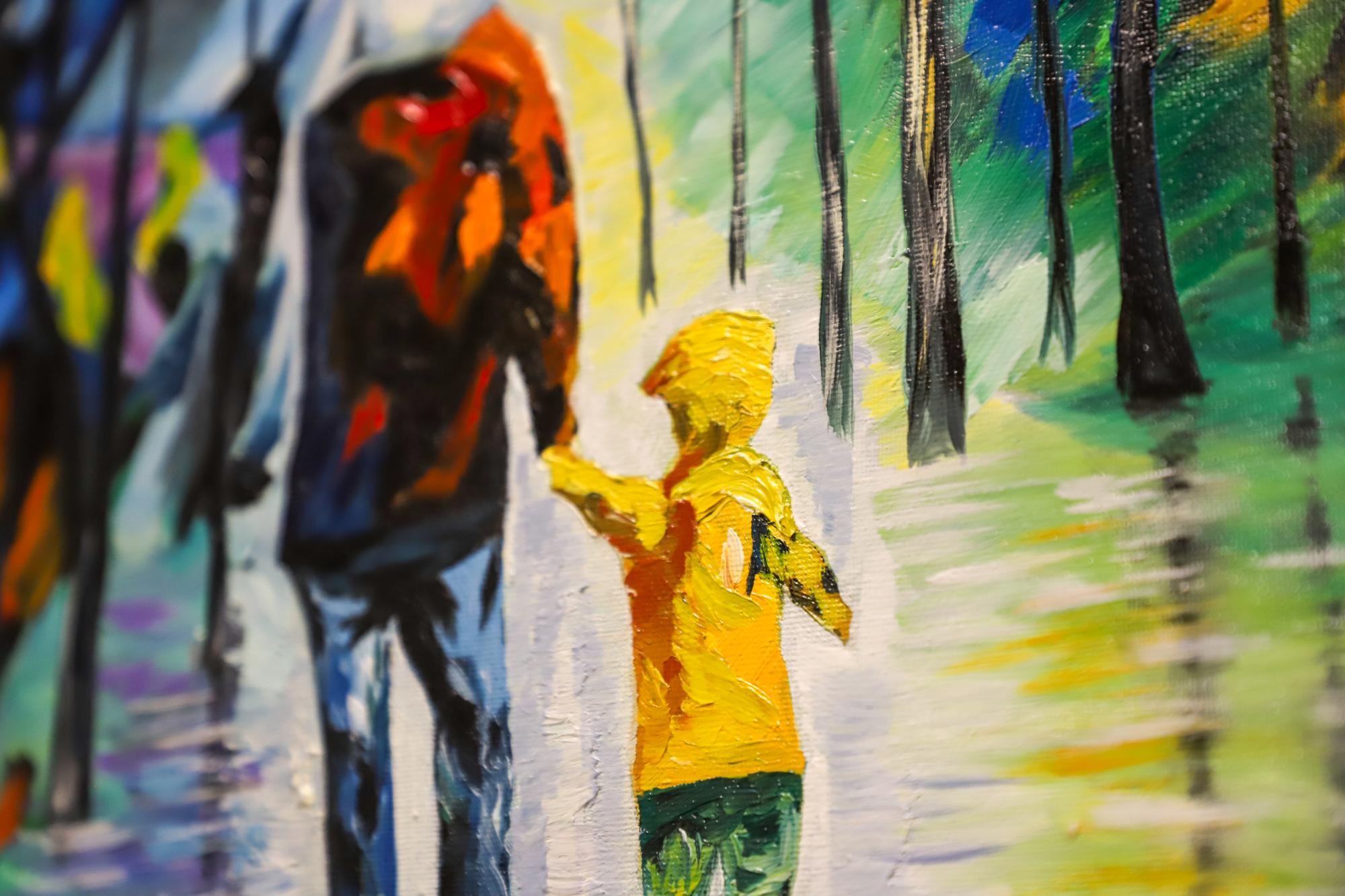 Bright details of a painting depicting a child wearing a yellow raincoat