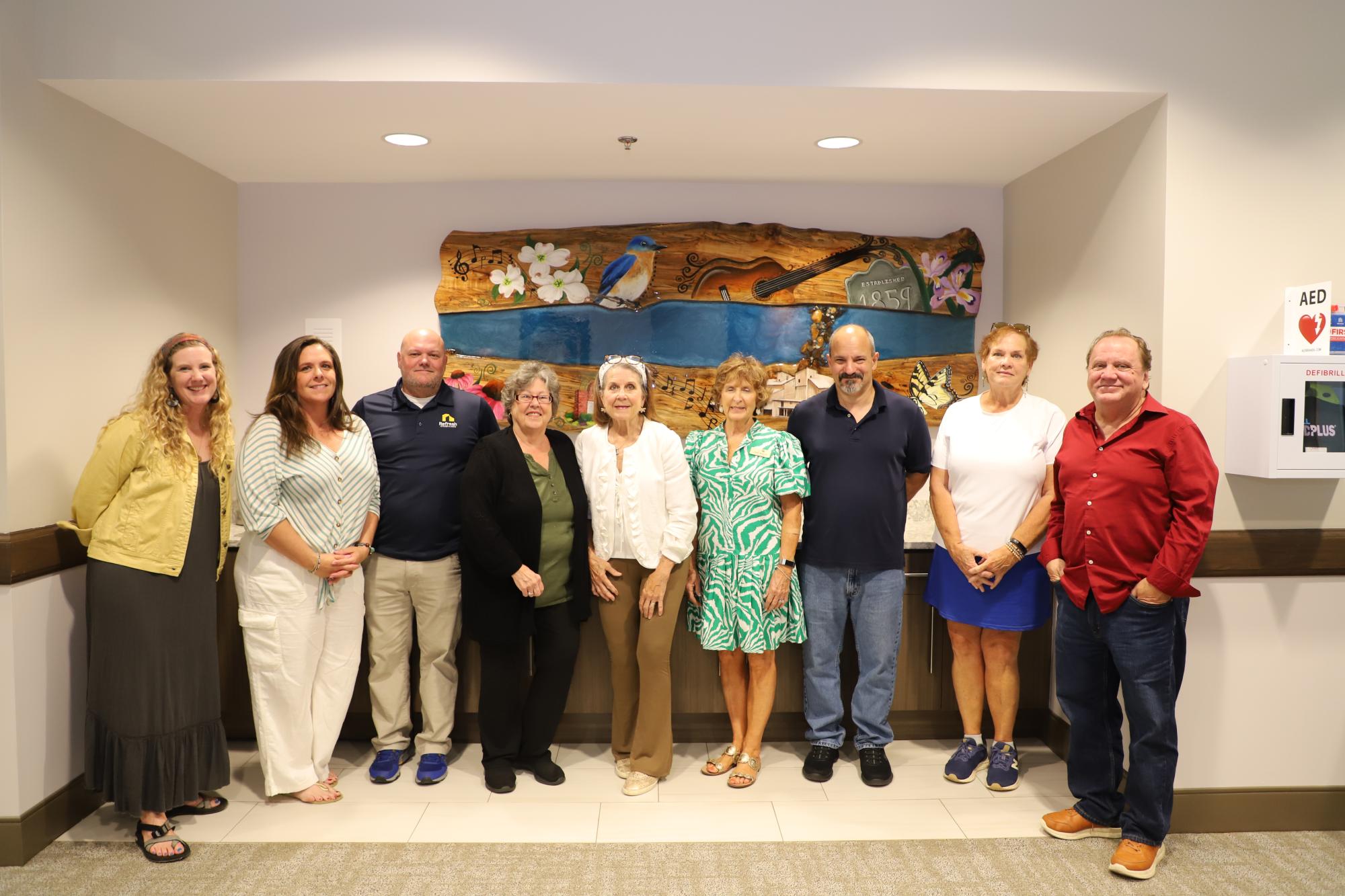 The Lewisville Public Art Advisory Committee stands with artists Missy and Jason by the new mural at the Mary Alice Warren Community Center in Lewisville.