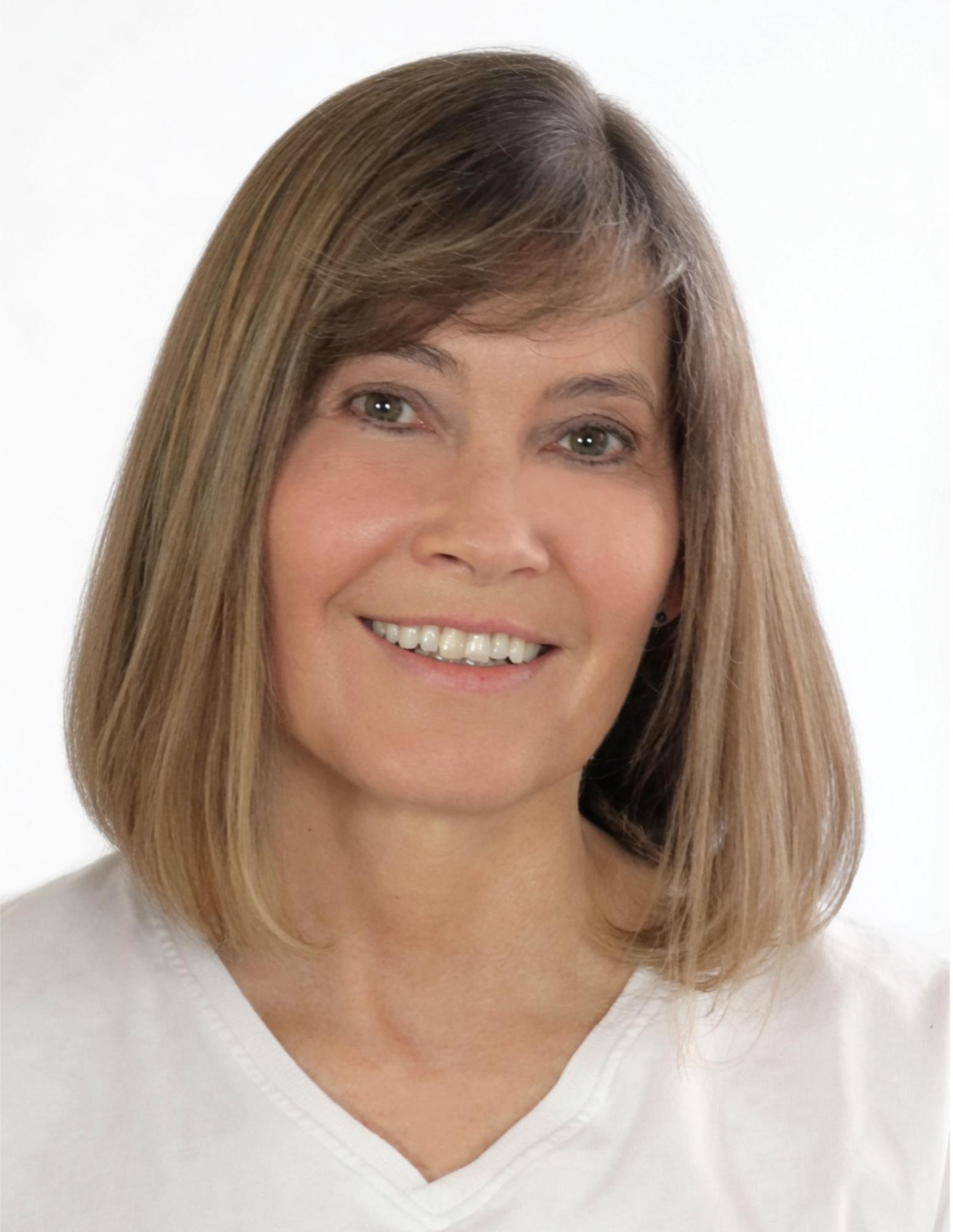 A white woman with shoulder length dirty blonde hair.